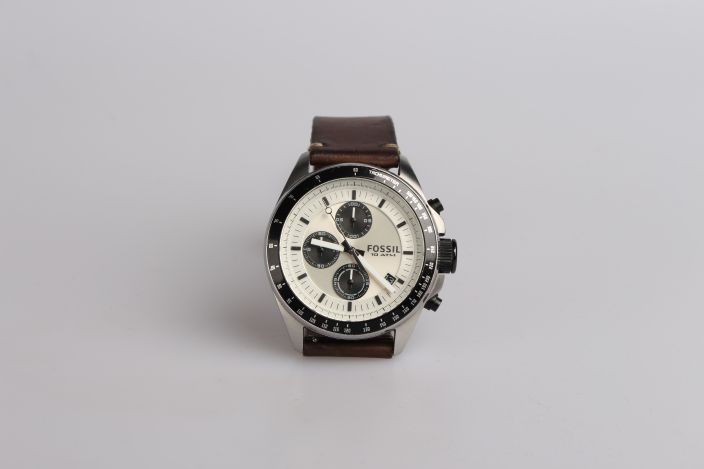 Round silver-colored Fossil chronograph watch with brown leather band